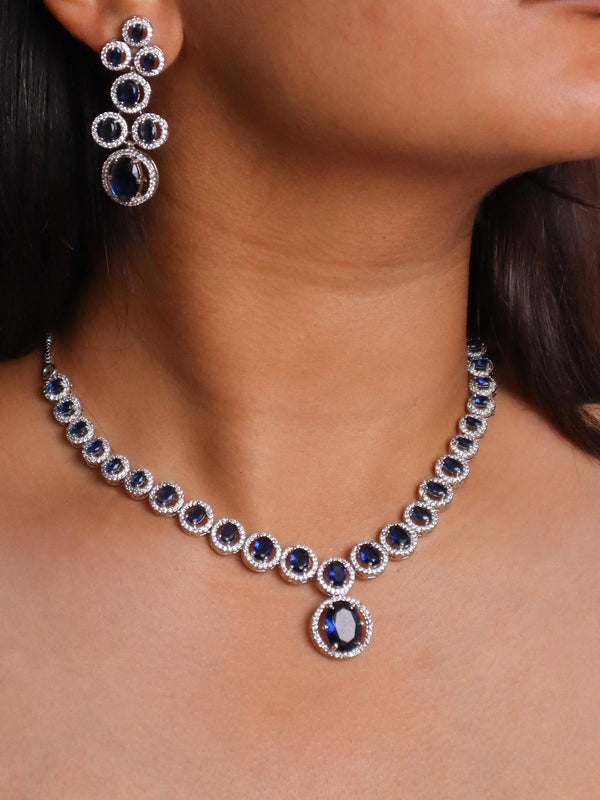 A closeup image of a girl wearing Dazzle Blue Sapphire Diamond Necklace Set -4 by Live Some India 