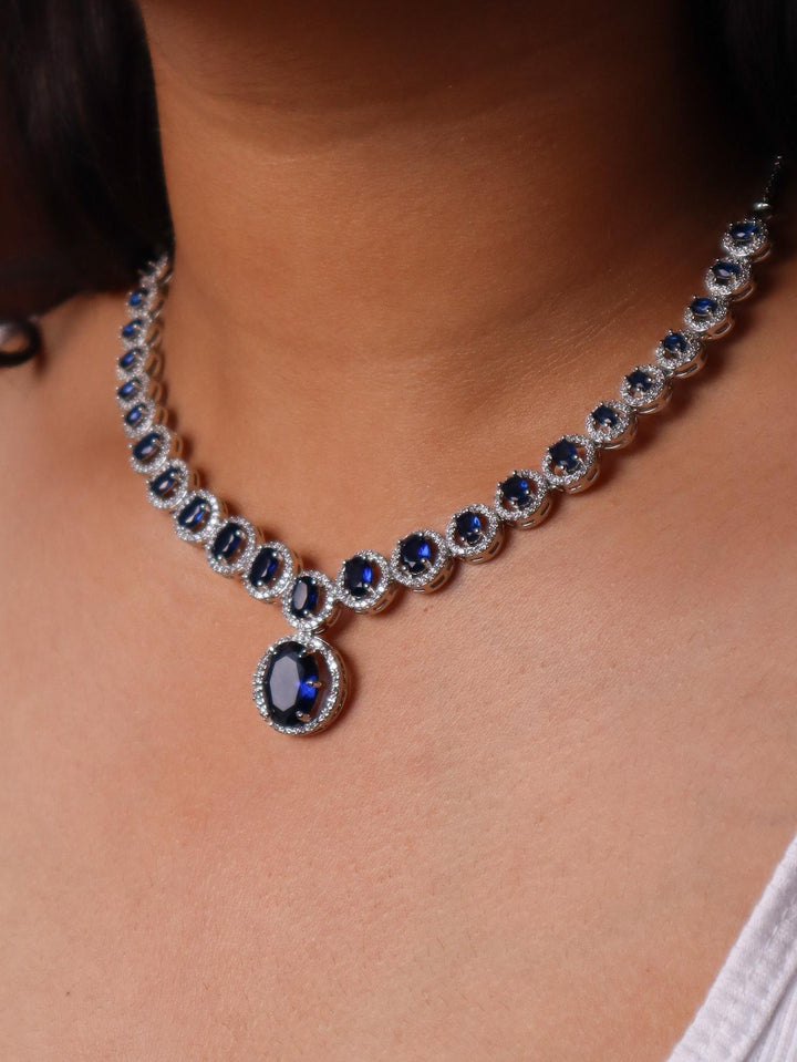 A closeup image of a girl wearing Dazzle Blue Sapphire Diamond Necklace Set -5 by Live Some India 