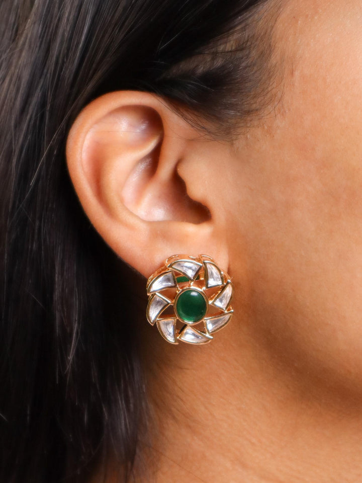 A closeup image of a girl wearing Delicate Green Stone Kundan Polki Earrings by Live Some India 