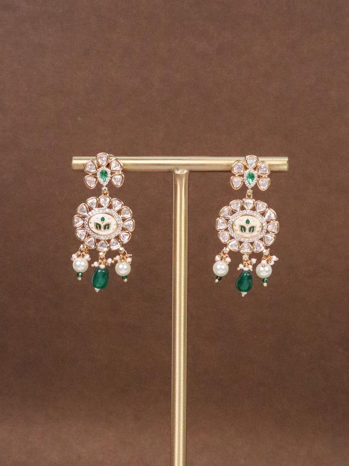 Dhariya Kundan Polki & Green Meenakari Dangle Earrings on earring stand with brown background