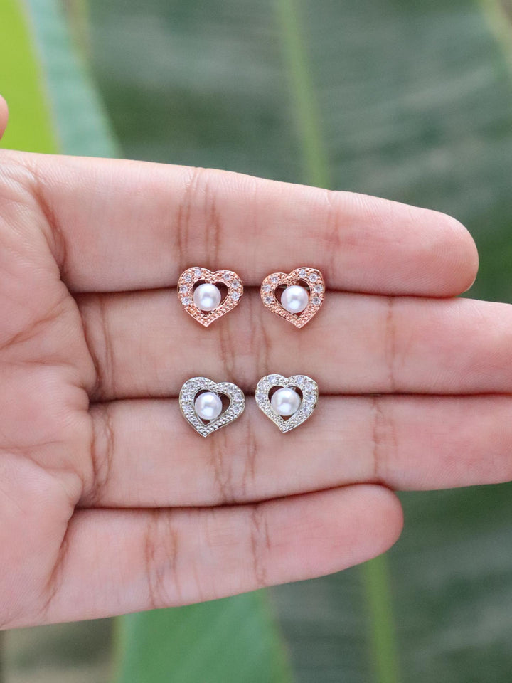 Diamond Heart & Pearl Earrings by Live Some India on hand with natural green leaves background