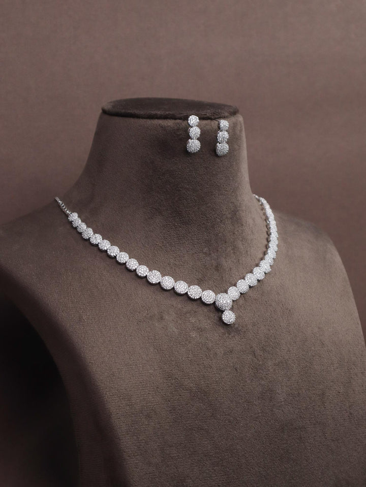 A closeup image of Elegant Diamond Necklace Set by Live Some India on a brown dummy 