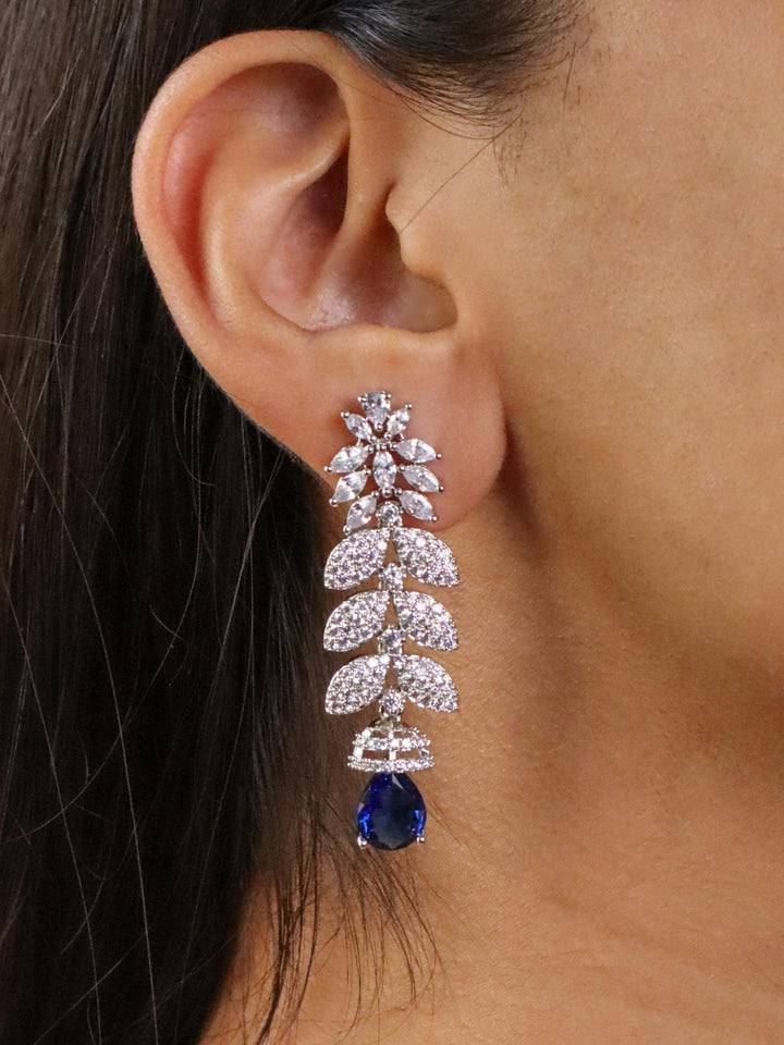 A closeup image of a girl wearing Elongated Sapphire Diamond Earrings by Live Some India 