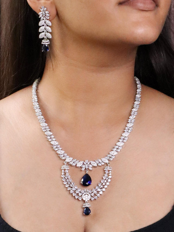 A closeup image of a girl wearing Elongated Sapphire Diamond Necklace Set by Live Some India 