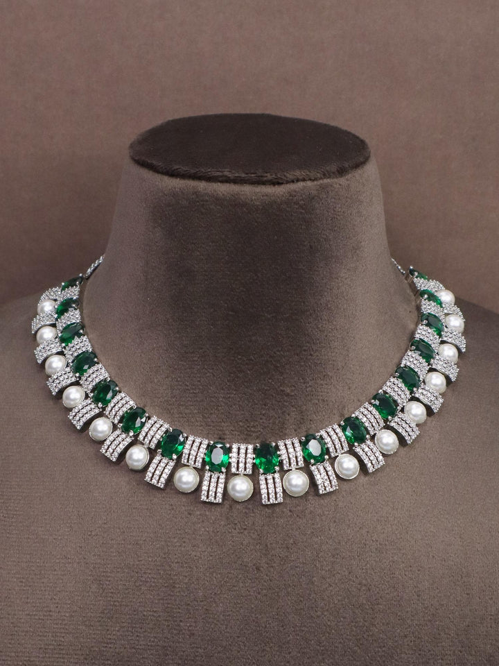 A closeup image of Emerald with Pearls Diamond Necklace Set by Live Some India on a brown dummy 