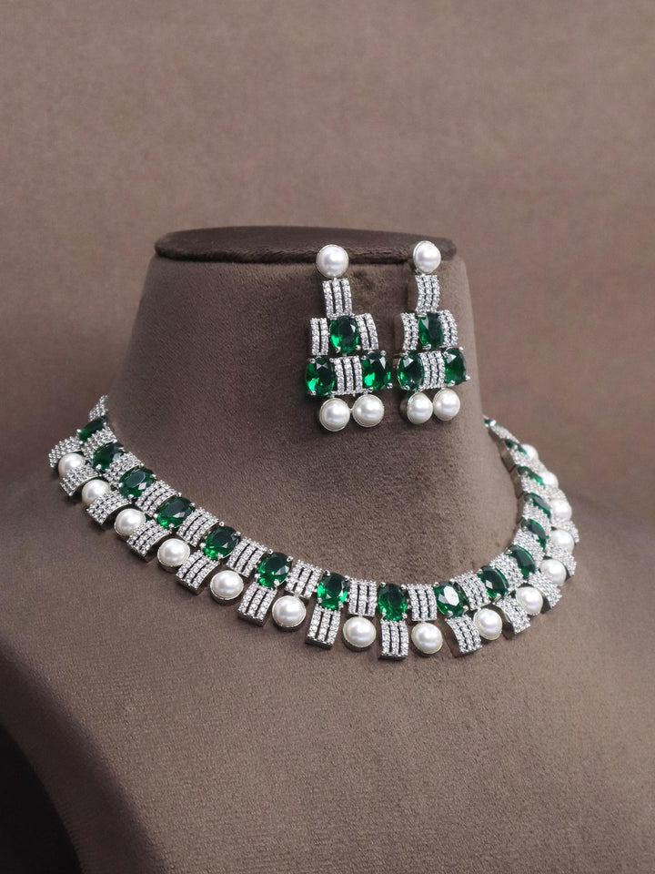 a closeup image of Emerald with Pearls Diamond Necklace Set -1 by Live some India on a brown dummy 