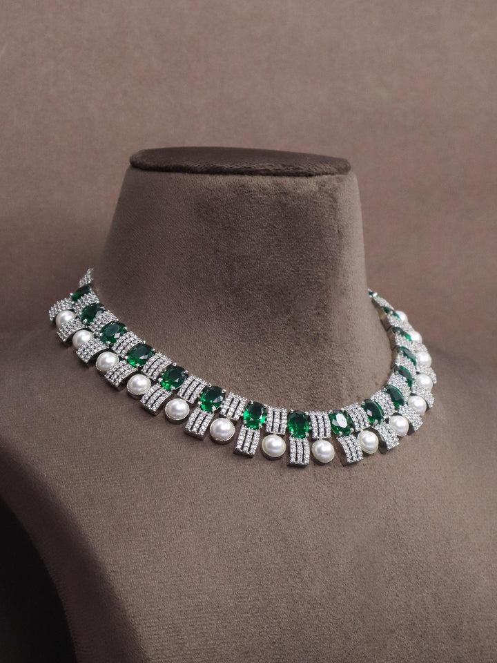 A closeup image of Emerald with Pearls Diamond Necklace Set -2 by Live Some India on a brown dummy 