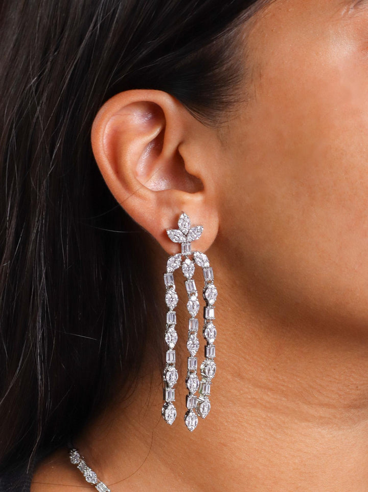 A closeup image of a girl wearing Ethereal Diamond Earrings by Live Some India 