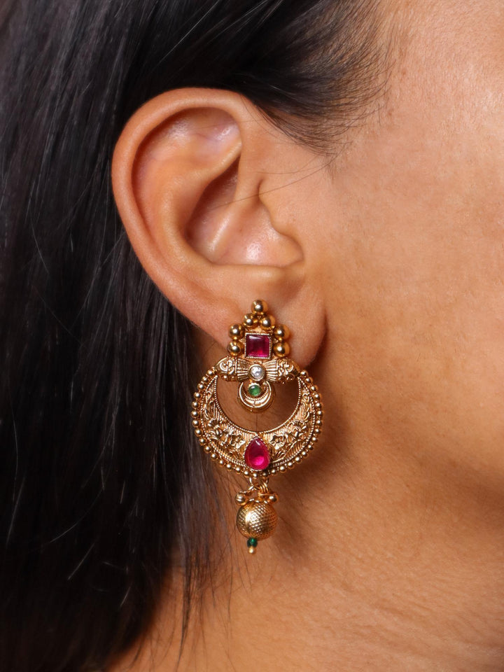 A closeup image of a girl wearing Exquisite 18K Gold Plated Earrings by Live Some India 