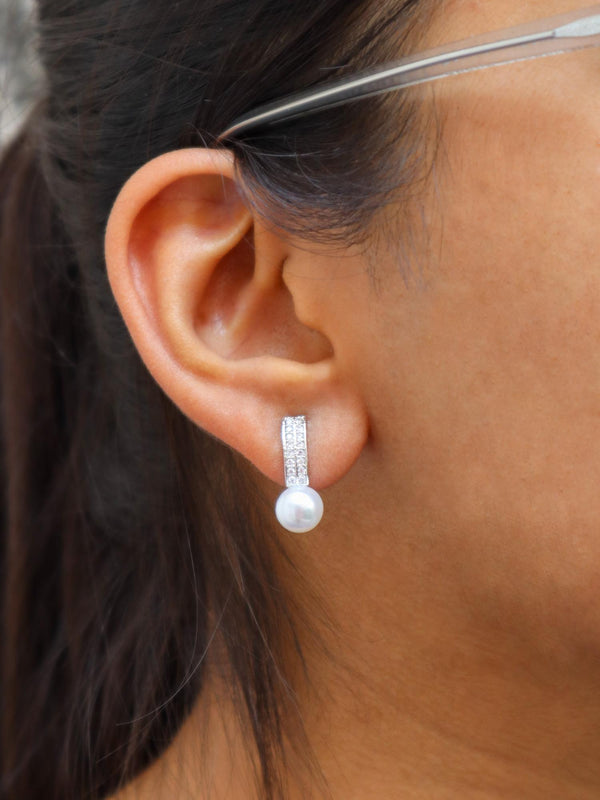 A closeup image of Extra Shine Pearl Earrings by Live Some India 