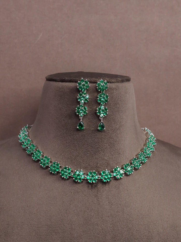 A closeup image of Flora Emerald Diamond Necklace set by Live Some India on a brown dummy 