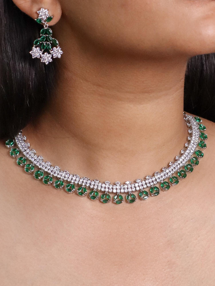 A closeup image of a girl wearing Floral Emerald Diamond Necklace Set by Live some India 