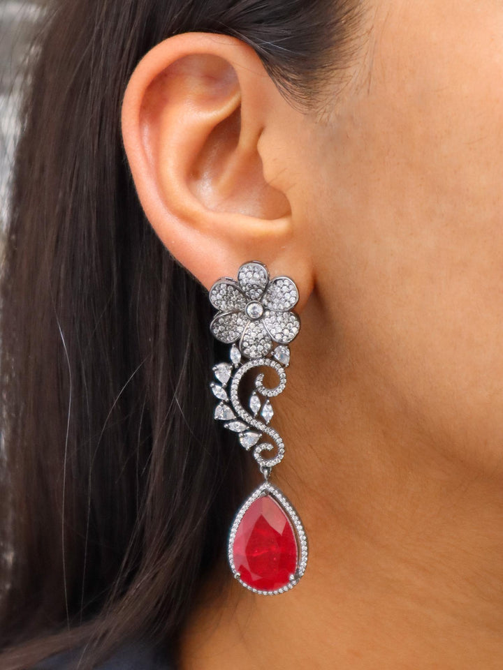 A closeup image of a girl wearing Floral Red Doublet Diamond Earrings -1 by Live Some India