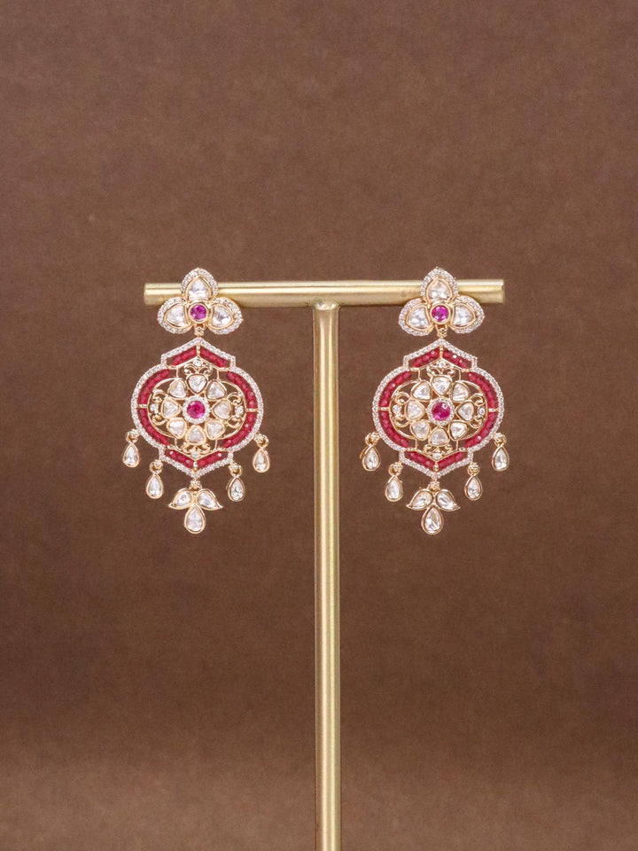 Gia Red Beaded Kundan Polki Dangle Earrings by Live Some India on a Earring stand with brown background.