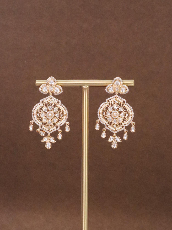 Gia White Beaded Kundan Polki Dangle Earrings by Live Some India on a Earring stand with brown background.