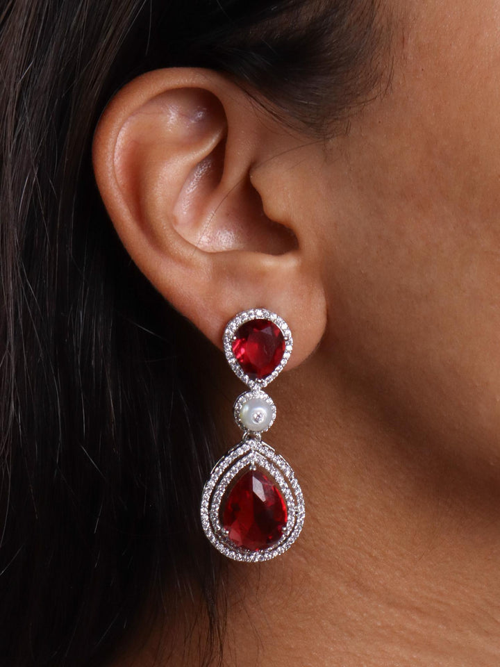 A closeup image of a girl wearing Grand Red Sapphire Diamond Earrings by Live Some India 