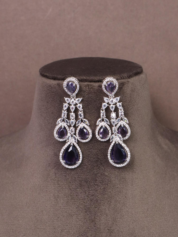 A closeup Image of Grand Sapphire Diamond Earrings by Live Some India on a brown dummy 