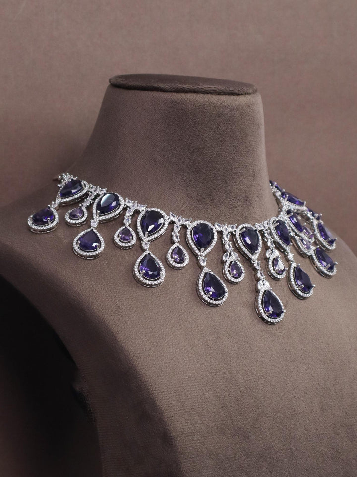 A closeup image of Grand Sapphire Diamond Necklace by Live Some India on a brown dummy 