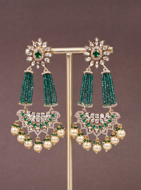 A closeup image of Green Beaded Kundan Polki Dangler Earrings by Live Some India on a brown background 