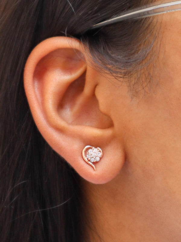 A closeup image of a girl wearing Heart Blossom Earrings by Live Some India 