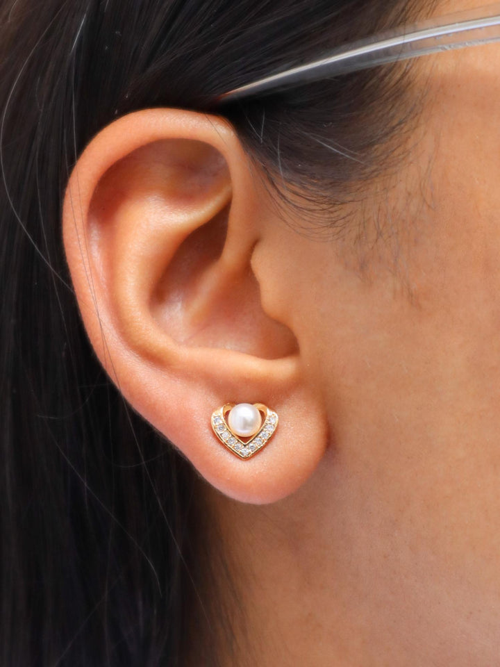 A closeup image of a girl wearing Heart of Pearl Earrings by Live Some India 