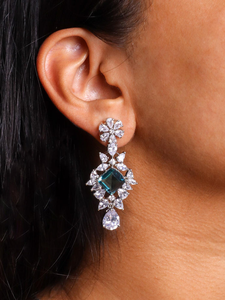 A closeup image of a girl wearing Iktara Diamond Earrings by Live Some India 