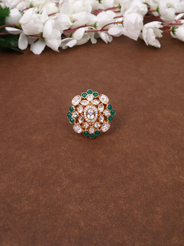 A closeup image of Inaya Green Kundan Polki Ring -2 by Live Some India on a brown background 