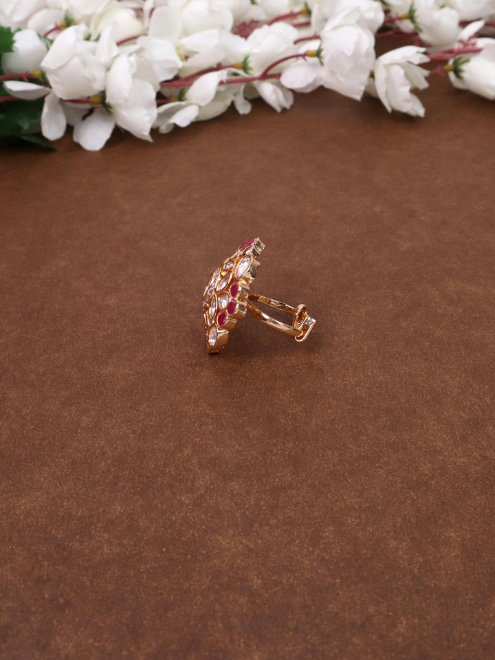 A closeup image of Inaya Red Kundan Polki Ring -2 by Live Some India on a brown background