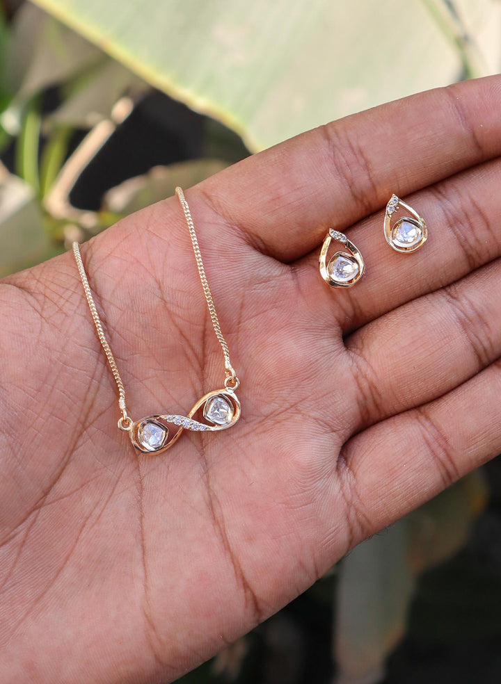 Infinity Kundan Polki Pendant Set with Earrings by Live Some India on hands with natural background