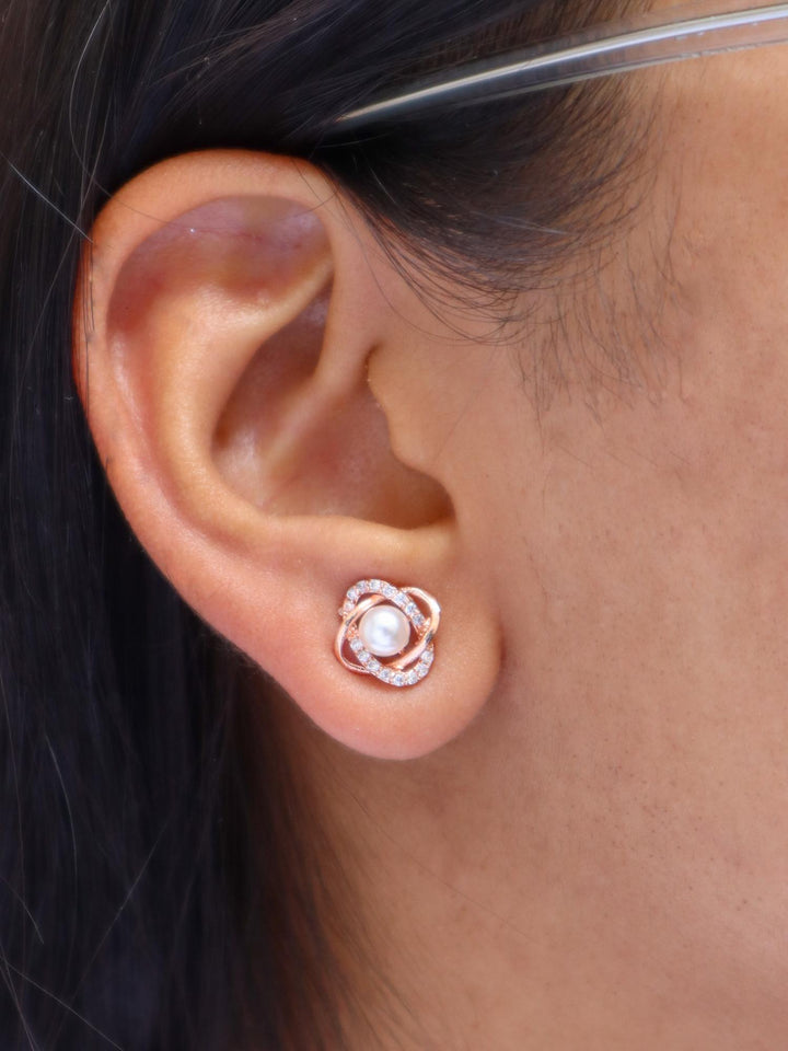 A closeup image of a girl wearing Intertwined Pearl Earrings by Live Some India 