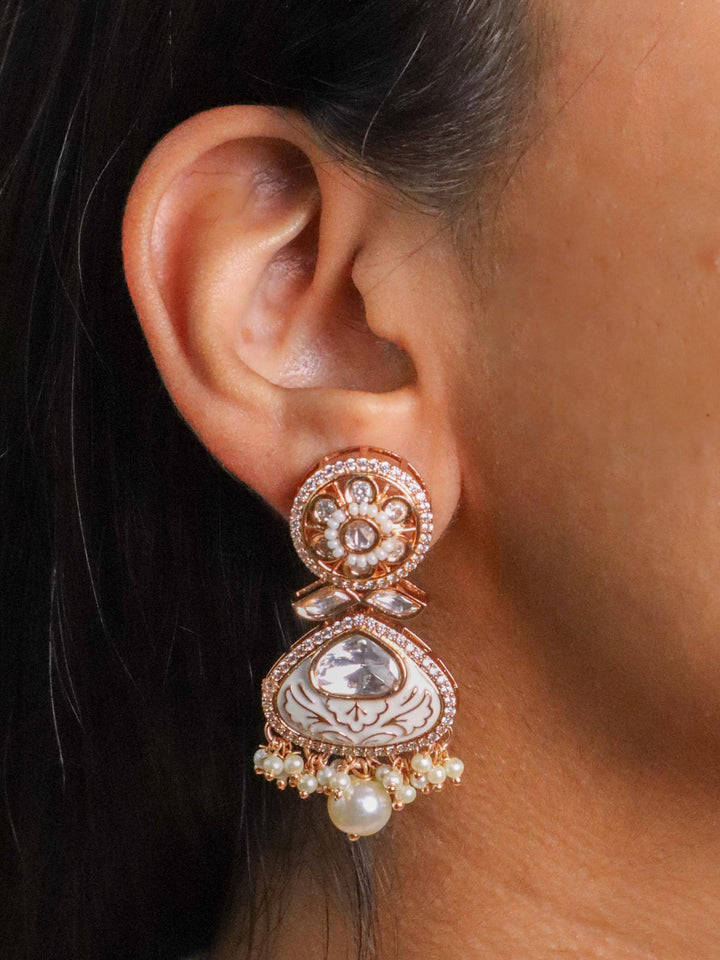 A closeup image of a girl wearing Ivory Reverie Kundan Polki Earrings by Live Some India 