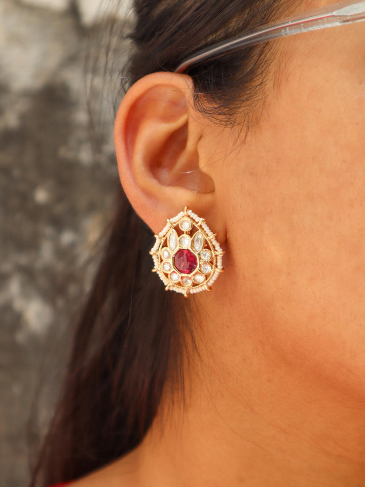 A closeup image of a girl wearing Jaani Kundan Polki Stud Earrings by Live Some India 