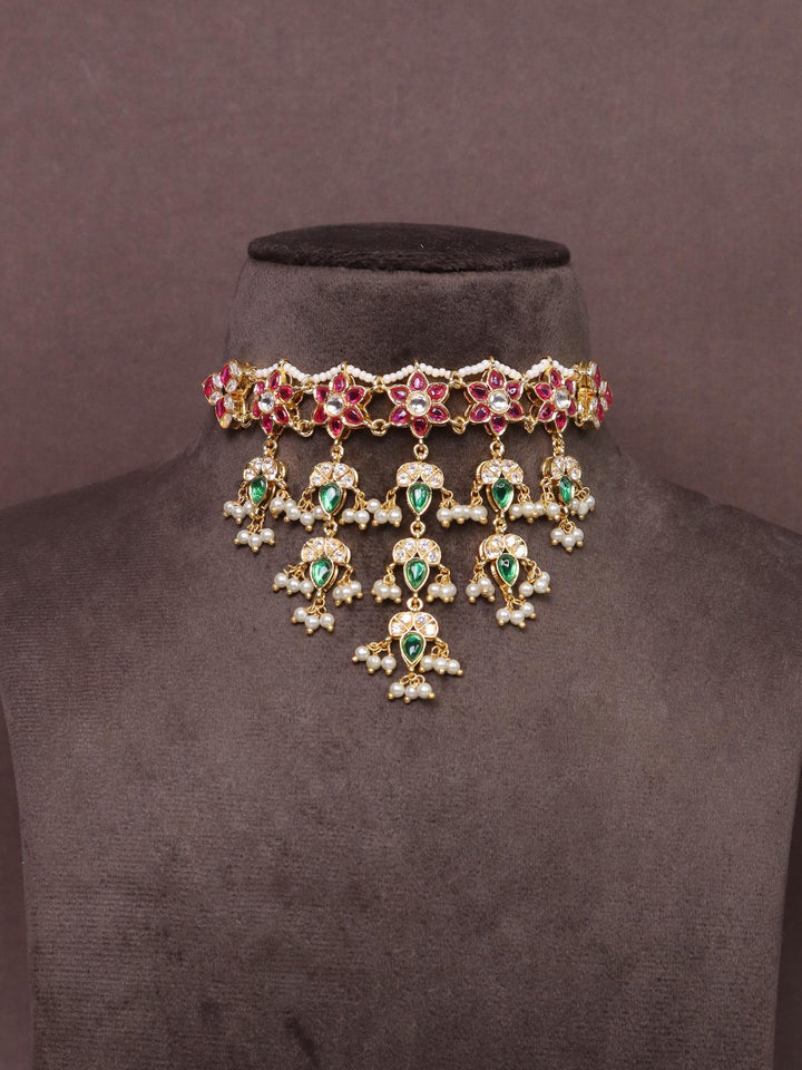 A closeup image of Jadau Kundan Polki Choker Necklace Set -3 by Live Some India on a brown background 