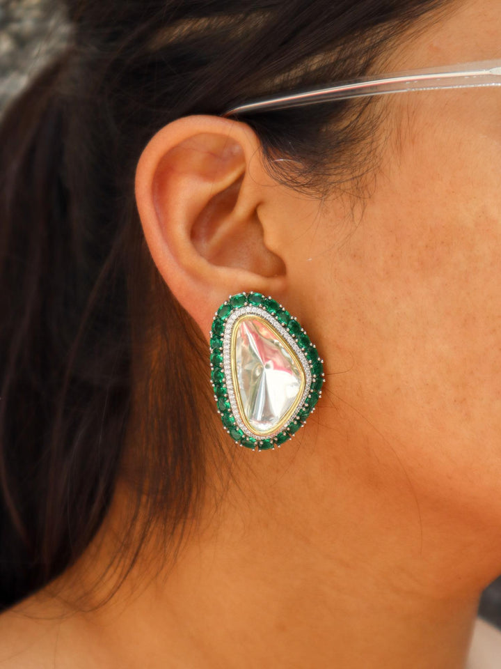 A closeup image of a girl wearing Kaira Kundan Polki Stud Earrings by Live Some India 