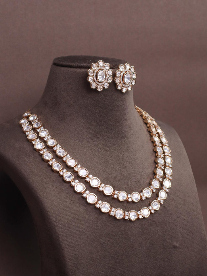 A closeup image of Layered Moissanite Kundan Polki Necklace Set  by Live Some India on a brown dummy 