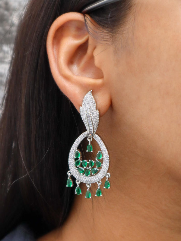 A closeup image of a girl wearing Leaf Drop Green Diamond Earrings by Live Some India 