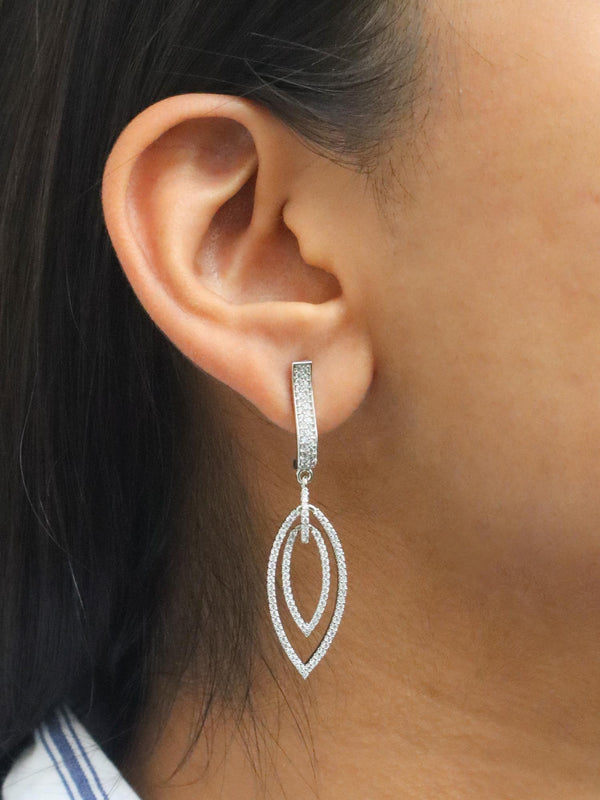 A closeup image of a girl wearing Leaf Duo Diamond Earrings -1 by Live Some India 