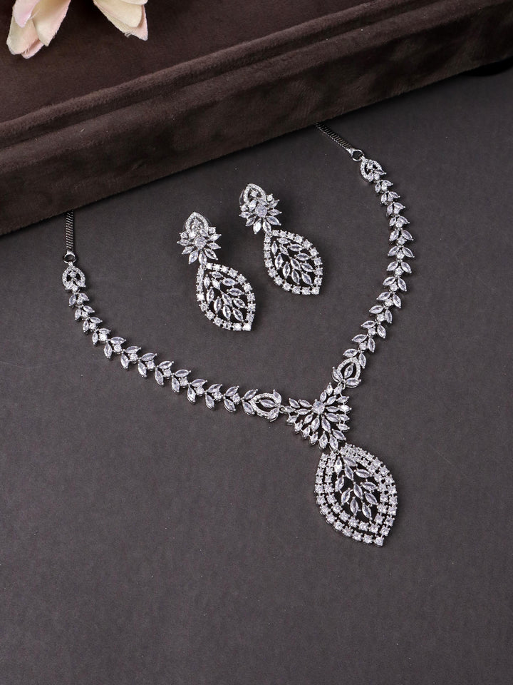 A closeup image of Leaf Studded Diamond Necklace Set -2 by Live Some India on a brown dummy 