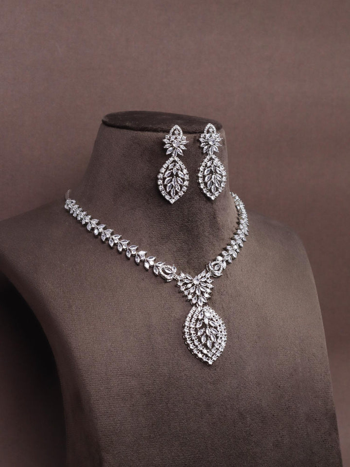 A closeup image of Leaf Studded Diamond Necklace Set -3 by Live Some India on a brown dummy 