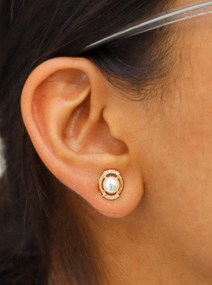 A closeup image of a girl wearing Loop of Pearls Earrings by Live Some India 