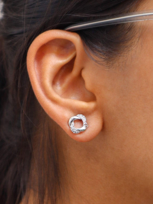 A closeup image of a girl wearing Loop of Silver Earrings by Live Some India 