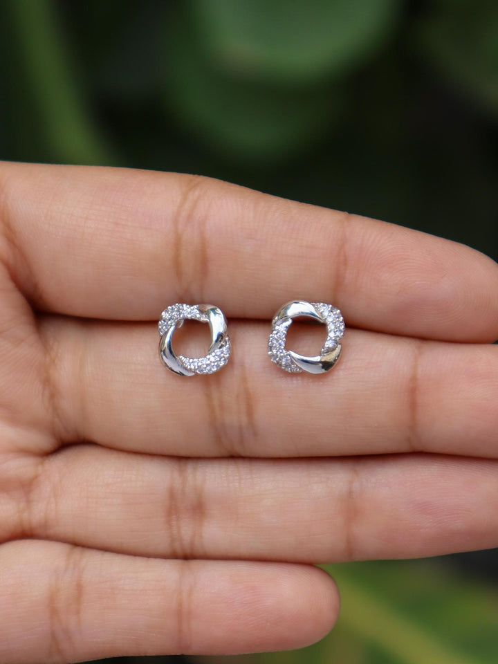 A closeup image of a girl wearing Loop of Silver Earrings by Live Some India 