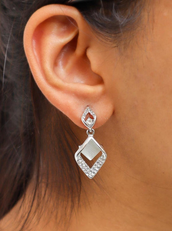 A closeup image of a girl wearing MOP Leaf Earrings by Live Some India 