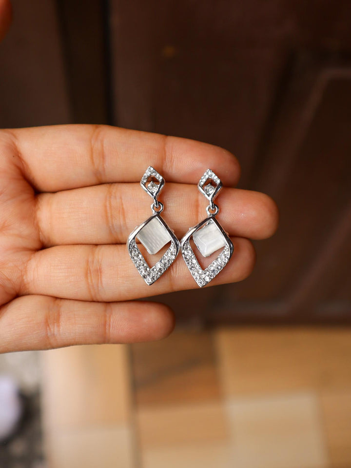 A closeup image of a girl holding MOP Leaf Earrings -1 by Live Some India 