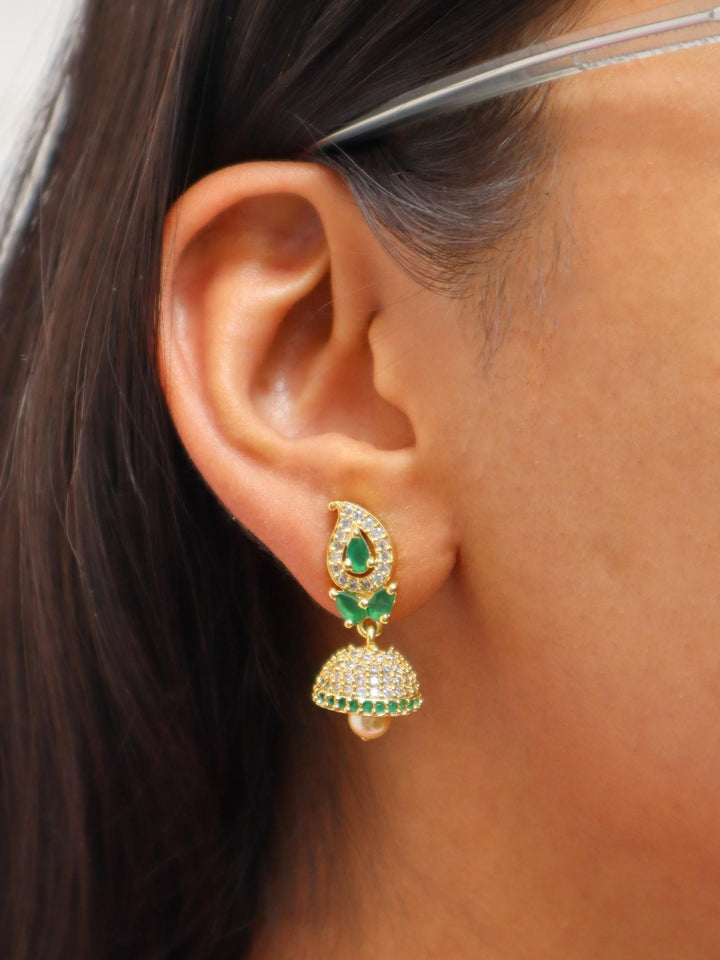 A closeup image of a girl wearing Maahi Kundan Polki Jhumka Earrings by Live Some India 