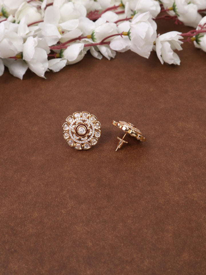 A closeup image of Maryam Maroon Kundan Polki Stud Earrings by Live Some India on a brown background 