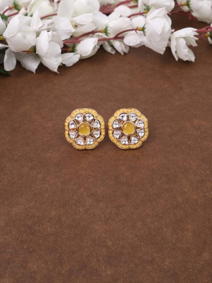 A closeup image of Maya Beaded Yellow Kundan Polki Stud Earrings by Live Some India on a brown background