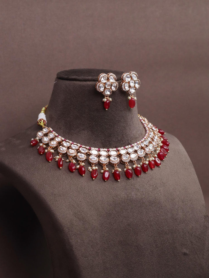 A closeup image of Maya Kundan Polki Necklace Set by Live Some India on a brown dummy 