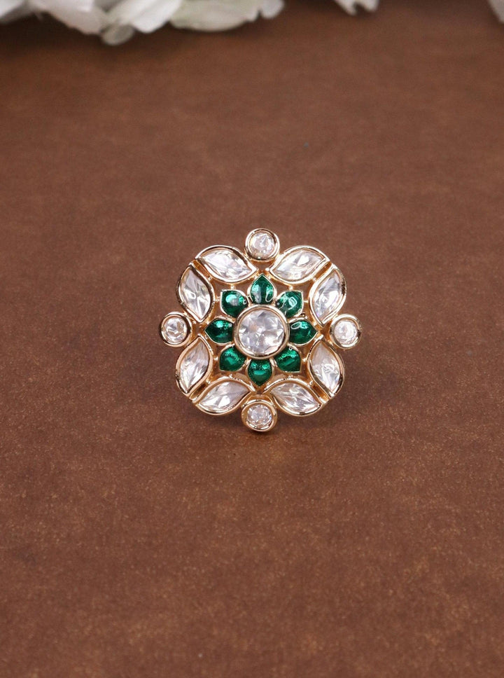 A closeup image of Mehar Meenakari Kundan Polki Green Ring by Live Some India on a brown background 