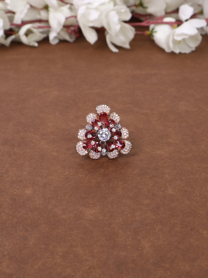 A closeup image of Mirai Red Contemporary Ring by Live Some India on a brown background 